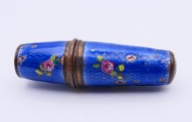 A blue enamel needle case containing a bobbin. 5.5 cm high.