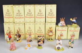 Twelve Royal Doulton Bunnykins figures including Helping Mother, Paper Boy, Susan, Polly, Tom,