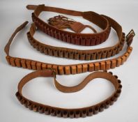 Four leather shotgun cartridge belts suitable for 12 and 20 bore.