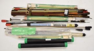 A collection of shotgun and rifle cleaning rods and brushes including wooden and metal examples,