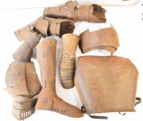 Nine pieces of Medieval style armour including breast plate, leg and foot vizor, arm, elbow and