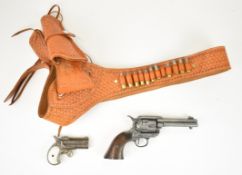 Two replica guns comprising a Derringer over and under pocket pistol with ornate decoration and a