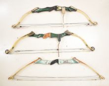 Three compound archery bows comprising Martin MT-6 Cougar II, one other Martin and Golden Eagle.