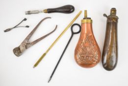 A collection of gun and shooting accessories including two copper and brass powder flasks, one G&