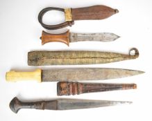 Three tribal knives including a Somalian example with bone handle grip, all with sheaths, longest