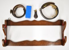 Four gun accessories comprising a two-gun shotgun or rifle display rack, copper powder flask in