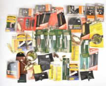 A large collection of gun cleaning kits and accessories including bore snakes, Bisley mops and