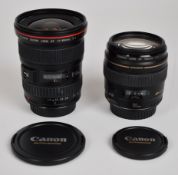 Two Canon digital SLR camera lenses comprising EF 17-40mm 1:4 L USM and EF 100mm 1:2, both with