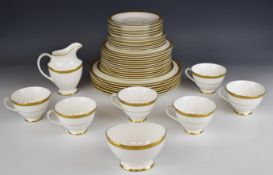 Royal Doulton dinner and tea ware decorated in the Royal Gold pattern, approximately thirty seven