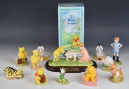 Twelve Royal Doulton Walt Disney Winnie the Pooh figures including Eeyore Loses a Tail tableaux