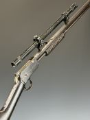 Winchester Model 1890 .22 Short pump-action rifle with military style scope, sound moderator and