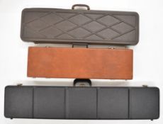 Three shotgun or rifle hard carry cases, all with padded interiors, largest 117cm ling.