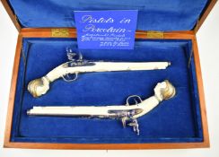 A pair of JAC of Malvern porcelain flintlock Maastricht pistols with faux ivory finish and 22ct gold