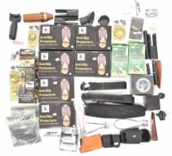 A collection of gun and shooting related items including Caldwell rifle rest bags, slings, forend