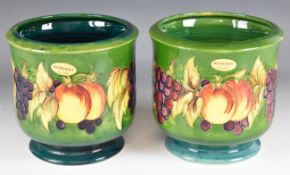 Pair of Moorcroft pedestal jardinières decorated in the Leaf and Berry pattern, H17.5cm