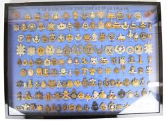Collection of one hundred and fifty cap badges in glazed frame, captioned 'Cap Badges of the Great