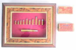 Rifle cartridge display board featuring eleven rook rifle cartridges including Kynoch 450-400, .