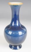 Chinese blue monochrome porcelain bottle vase with flared rim and six character Kangxi mark to base,