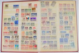 A small red stockbook containing a Malta stamp collection, mint and used from Queen Victoria