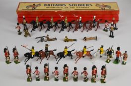 Thirty-three Britains painted metal toy soldiers to include Indian Lancers, Scottish Infantry,