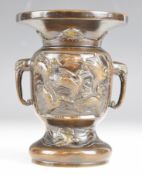 Chinese twin handled bronze vase with bird decoration, 13.6cm tall.