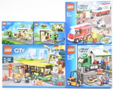 Five Lego City sets comprising Starter Set 60023, Cargo Truck 60020, Bus Station 60154 and two