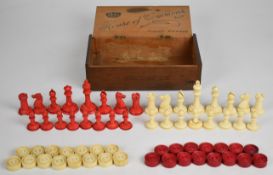 A carved bone chess set with one side stained red, together with a similar draughts set, height of