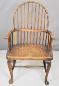18thC elm seated Windsor armchair with wide seat and shaped arms, raised on front cabriole legs,