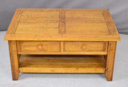 Contemporary oak coffee table with rising / cantilever top and storage under to enable a person to