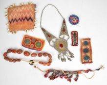 A collection of African or tribal jewellery including tooled white metal necklace, polished stone