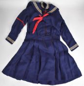Victorian girl's sailor dress with red ribbon neck tie
