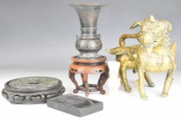 Chinese hardwood stands, brass Dog of Fo figure, bronze disc and vase (no base) etc, tallest 22cm