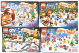 Four Lego City Christmas Advent Calendars comprising sets 4428, 60099, 60063 and 60024, in sealed