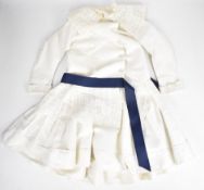 Victorian child's dress with lace trim and blue ribbon belt