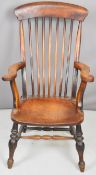 19thC elm seated Windsor armchair with scrolling armrests and shaped back, H106cm