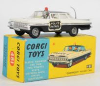 Corgi Toys diecast model Chevrolet Police Car with black and white body, silver trim, spring