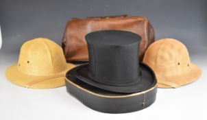 Two Bermuda hats, collapsible top hat in box by Henry Heath, London and a leather Gladstone bag