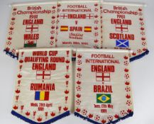 Five England international football pennants dating to 1981 for games against Spain, Brazil,