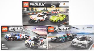 Three Lego Speed Champions racing car sets comprising Porsche 911 75888, Mercedes-AMG F1 76909 and