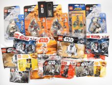 Twenty-three Lego Star Wars minifigure packs to include R2-D2, DJ, Darth Vader, R3-M3 and BB-8,