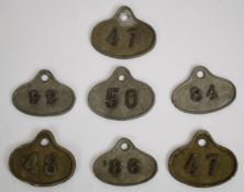 Seven cast metal wine bin labels / tickets, most with L. Lumley & Co, America Square, London
