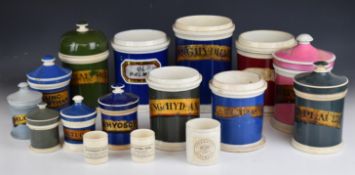 Sixteen vintage apothecary / medicine / chemist jars, most with Latin script, some covered,