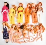 Eight Dollykins Action Girl dolls in vintage outfits, together with a collection of spare heads