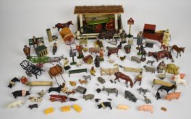 A collection of Britains painted metal farm animals, workers, carts, machinery and buildings.