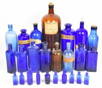 Twenty one vintage apothecary / medicine / chemist bottles, mostly blue glass for poison, tallest