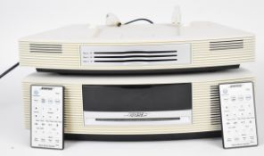 Bose Wave AWRCC6 radio/multi disc CD player, with two remote controls.