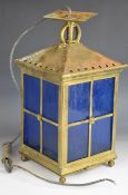 Arts and Crafts style brass electric hanging light with striated blue glass panels, H40cm