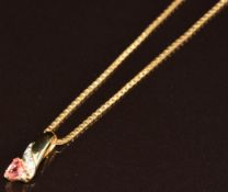 An 18ct gold chain made up of boxed links with 9k gold pendant set with a pink sapphire and
