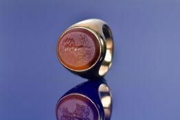 An 18ct gold signet ring set with a 19thC intaglio seal depicting a chariot and charioteer, 15.6g,