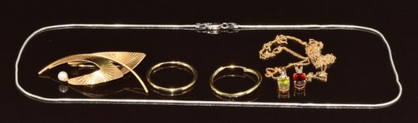 A 9ct gold brooch set with a pearl, pair of 9ct gold earrings, two 9k gold pendants set with peridot